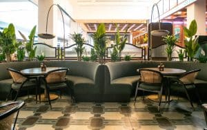 Restaurant seating area enhanced with integrated indoor plants and planters, adding greenery and ambiance to a modern dining space